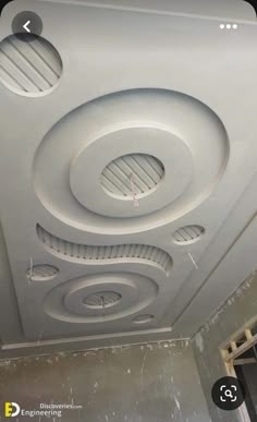 the ceiling is painted white and has round holes in it