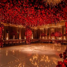 a dance floor with red flowers hanging from the ceiling