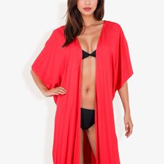 The Anna-Kaci Women's Duster Style Cover-Up with Open Front and Wide Sleeves is the perfect addition to your beach or poolside wardrobe. This flowing cover-up features an open front design that allows for easy wear and removal, while the wide sleeves add a touch of bohemian elegance. Made from lightweight, breathable fabric, it ensures comfort and coolness on hot summer days. The versatile design makes it ideal for layering over swimsuits, bikinis, or casual outfits, providing a chic and effortl Red Beachwear For Vacation, Red Beachwear Swimwear For Vacation, Casual Red Swimwear For The Beach, Casual Red Swimwear For Beach, Red Swimwear For Beach Party Vacation, Solid Summer Tops For The Beach, Solid Summer Tops For Beach, Open Front Summer Swimwear For Pool, Red V-neck Top For Beach Season