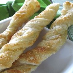 some bread sticks are in a white bowl