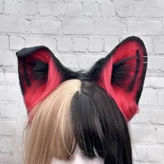 a black and red cat ears headpiece on top of a mannequin's head