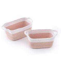 two pink and white baskets sitting on top of each other in front of a white background