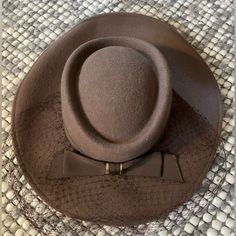 Stunning 100% Wool Hat From 1940s. Still Has The Tag On It. Features Beautiful Bow Detail And Mesh Accent. Also Has Elastic Chin Band To Hold It On. Perfect For A Tea Party Or Derby. No Size Listed Inside Space Measures 7.5” Length X 6.5” Width Vintage Beige Fedora Felt Hat, Vintage Beige Felt Hat For Winter, Brown Brimmed Hat For Vintage Events, Brimmed Brown Hat For Vintage Events, Vintage Beige Felt Hat With Flat Brim, Vintage Beige Wide Brim Fedora, Brown Vintage Cloche Hat With Flat Brim, Vintage Cloche Hat With Curved Brim For Fall, Vintage Brown Cloche Hat With Flat Brim