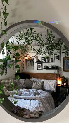 there is a mirror that has some plants on the wall above it and a bed in front of it