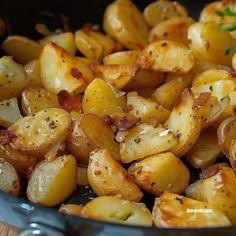 cooked potatoes in a pan with herbs and seasoning