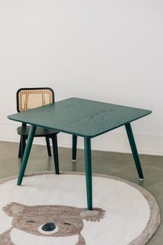 two chairs and a table with a bear rug on the floor in front of it