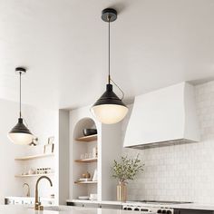 a kitchen with an island and two pendant lights hanging over the counter top, along with open shelving