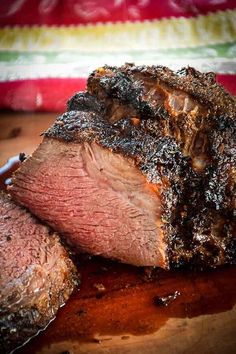 a piece of meat sitting on top of a wooden cutting board