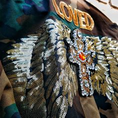 a close up view of the back of a jacket with gold sequins on it