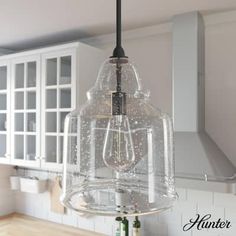 a glass light hanging from the ceiling in a kitchen