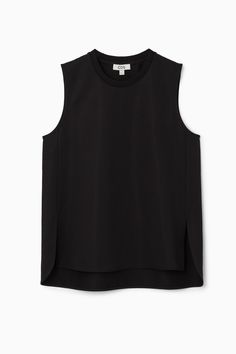 The tank top is a foundational part of any wardrobe. Made from a soft cotton-blend, this black one has side slits and a curved, stepped hem that adds shape to any outfit when left untucked. Regular fitSleeveless Shell: 61% Cotton, 23% Polyester, 16% Elastane. Excluding trims / Machine wash Back length of size S is 72cm / Model wears a size S Black Tank Muscle Tee For Layering, Black Muscle Tee Tank For Layering, Fitted Sleeveless Top With Side Slits, Culotte Shorts, Cos Tops, Denim Sweater, Vest Shirt, Knitwear Cardigan, Split Hem