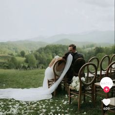 a bride and groom sitting on chairs in the grass