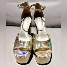 Contemporary And Sleek, The Marc Fisher Ltd Della Platform Sandal Will Be A Wardrobe Staple. The Della Features A Fashion Forward Platform On The Upper, Trendy Almond Shaped Toe And An Ultra High Block Heel That Is Sure To Impress. Brand New But No Tags Or Box. Underside Has Little Usage Caused By Walking Within Store Before Purchase. Metallic Sandals With Stacked Heel For Party, Metallic Platform Heels In Synthetic Material, Metallic Platform Heels With Synthetic Material, Summer Metallic Platform Heels, Metallic Round Toe Synthetic Heels, Metallic Synthetic Round Toe Heels, Metallic Round Toe Heels, Metallic Synthetic Heels With Round Toe, Almond Shaped