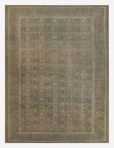 an antique rug with intricate design in grey tones