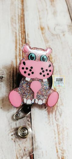 *Hippo is made with pink/purple glitter mix. If you want different colors, please send me a message, I'd be more than happy to customize! *Badge reels are made to order. Please allow 2-3 weeks for items to be made prior to shipping. *Hippo is about 2 inches. The are made with acrylic and UV resin. *Alligator swivel retractable badge reel or belt clip are available. *Shipped badge reels are enclosed in a zip bag packaging. *Epoxy can break if handled harshly or dropped. *Items are handmade and sl Novelty Pink Badge Holder For Birthday, Cute Pink Badge Reel For Birthday, Fun Pink Badge Holders, Cheap Personalized Pink Badge Reel, Rebecca Lynn, Pink Badge Reel With Swivel Clip As Gift, Novelty Pink Badge Reel, Customizable Novelty Multicolor Badge Reel, Novelty Pink Personalized Badge Reel