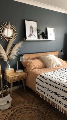 a bed room with a neatly made bed next to a ladder and pictures on the wall