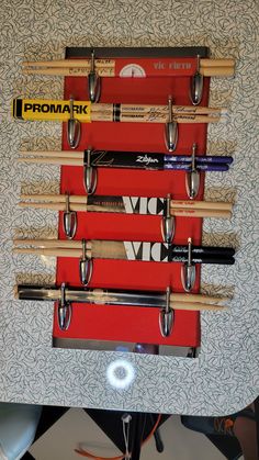 a wall mounted rack with several baseball bats