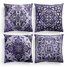 four pillows with different designs on them in purple and white colors, each featuring an intricate design