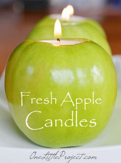 green apples and candles are sitting on a plate with the words, fresh apple candles