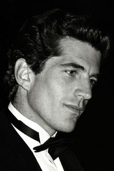 a black and white photo of a man in a tuxedo