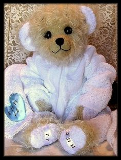 a brown teddy bear sitting on top of a chair