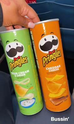 two cans of pringles sitting next to each other