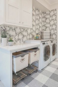 a washer and dryer in a laundry room with patterned wall paper on the walls