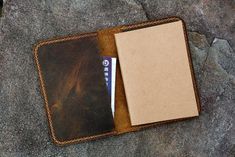 an empty wallet sitting on top of a rock