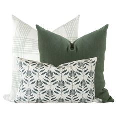 three pillows with green and white designs on them