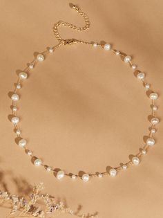 Enhance your neckline with the elegance of this dainty choker necklace. Featuring a delicate line of pearl stones in various sizes, it exudes timeless beauty and sophistication. Pearl Choker Necklace For Wedding, Pearl Choker For Wedding, Chic Pearl Choker Necklace For Wedding, Wedding Pearl Choker Chain Necklace, Chic Pearl Choker For Wedding, Classic Pearl Drop Choker Necklace, Chic Pearl Chain Choker, Elegant Pearl Choker With Clavicle Chain, Chic Pearl Drop Choker Necklace