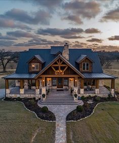 this is an image of a large house in the country side with stone steps leading up to it