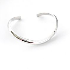 This solid sterling silver curved bracelet cuff has a polished finish with a high dome half round edge. It is an elegant and timeless design. I have shaped the bracelet cuff so it fits the natural curve of your wrist and sits very comfortably on your hand particularly when you are writing or using a computer. The bracelet cuff curves down at the front and you simply slide it across the wrist approximately where you would wear your watch.  I have used a very heavy gauge metal so it will not go ou Modern Shiny Cuff Bangle Bracelet, Modern White Gold Cuff Bracelet With Shiny Finish, Modern Silver Cuff Bracelet With Shiny Finish, Modern Round Cuff Bracelet With Shiny Finish, Modern Shiny Round Cuff Bracelet, Modern Sterling Silver Cuff Bracelet With Polished Finish, Minimalist Polished Sterling Silver Bracelet For Formal Occasions, Silver Open Cuff Bracelet With Polished Finish, Classic Silver Open Cuff Bracelet