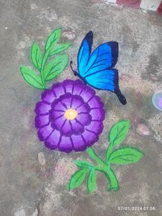 a blue butterfly sitting on top of a flower next to a purple flower with green leaves