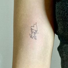 a woman's arm with a small tattoo of a cat on the back of her leg