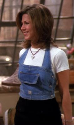 a woman in overalls and a white t - shirt