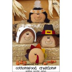 three handmade scarecrows sitting on top of hay