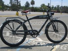 a black bicycle parked in a parking lot