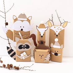 some cardboard boxes with animals on them and one has a raccoon in it