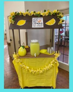 a lemonade stand is decorated with yellow flowers