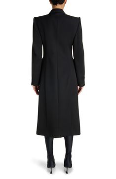 Demna revisits the iconic hourglass shape with this wool-gabardine coat channeling the exaggerated tailoring of master courtier Cristóbal Balenciaga. 48" length (size 38fr) Double-breasted button closure Peaked lapels Four-button cuffs Chest welt pocket; front flap pockets Cupro lining 100% wool Dry clean Made in Italy Designer Clothing Luxury Gabardine Long Wool Coat, Luxury Long Sleeve Gabardine Wool Coat, Balenciaga Hourglass Coat, Luxury Long Sleeve Wool Coat With Double-breasted Button, Balenciaga Coat, Luxury Black Wool Coat With Double-breasted Button, Cristóbal Balenciaga, Hourglass Shape, Black Coat