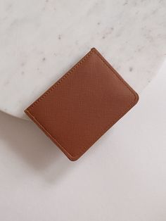 The Saffiano Leather Card Holder Wallet is a sleek, structured and high quality wallet to hold your business cards, school id's or credit cards. The card holder is unisex and is perfect for gifting to a loved one or to treat your self with a new sleek wallet. Three Card Slots Sleek Flat Back 4.25x3x0.5 THIS ITEM IS FINAL SALE Trendy Bifold Card Holder With Rfid Blocking, Trendy Rfid Blocking Bifold Card Holder, Trendy Rfid-blocking Bifold Card Holder, Trendy Bifold Travel Card Holder, Trendy Brown Card Holder For Travel, Trendy Brown Card Holder With Card Slots, Trendy Leather Card Holder With Rfid Blocking, Trendy Leather Rfid Blocking Card Holder, Classic Rfid Blocking Card Holder As Gift