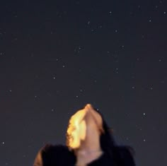 a man is looking up at the stars in the night sky with his eyes closed