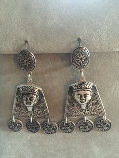 Stunning, statement earrings from 1970s Spain. Pharaoh heads dominate the design with flanking birds. Silver disks with 'hieroglyphics' dangle from the heads.  These are textured silver (color), lever back, earrings. The style is called Damascene. Because they are Good, Vintage costume jewelry they do have sterling silver content - but not rated at 925. The earrings measure just over 2 1/8" (5.4cm) long from top to bottom. These earrings are from the inventory of 2 fantastic gift shops that were Collectible Bohemian Earrings, Bohemian Clip-on Metal Earrings, Bohemian Collectible Earrings, Gift Shops, Bohemian Hippie, Hippie Bohemian, Pierced Earrings, Vintage Costume Jewelry, Pretty Jewellery