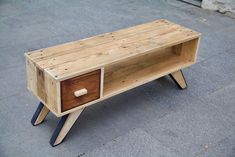 a wooden table with two drawers on it