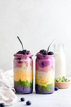 two jars filled with food sitting on top of a table