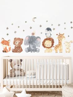 a baby's nursery room with wall decals featuring animals and stars