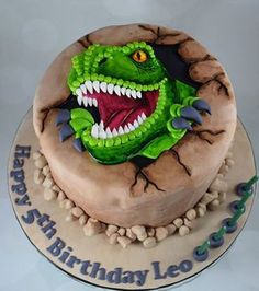 a birthday cake with a green dragon on it