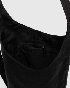 A slouchy, softly structured nylon bag with an adjustable strap. Interior zip pocket with a magnetic closure. The details- Heavyweight nylon (59% recycled) 9.5 in. H × 7 in. W × 4.25 in. D 39 in. adjustable strap Machine washable Black Candy Apples, Sling Bag Black, Black Candy, Nylon Bag, Sling Bag, Magnetic Closure, New Product, Zip Pockets, Adjustable Straps