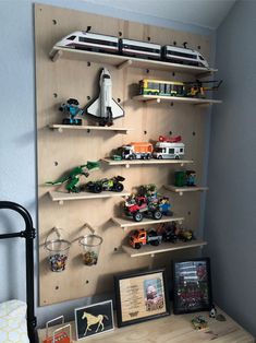 a wooden shelf filled with toy cars and toys