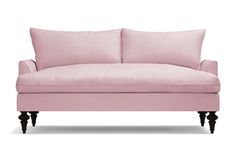 a pink couch with two pillows on the back and one arm upholstered to it